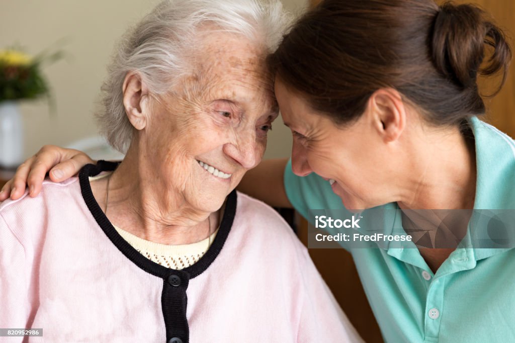 Dementia and Occupational Therapy - Home caregiver and senior adult woman Senior Adult Stock Photo