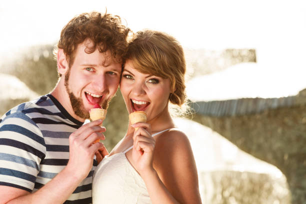 istock young couple eating ice cream outdoor 820955742