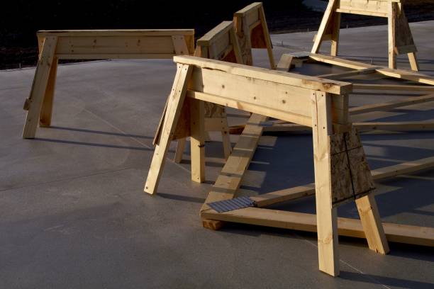 A family of four saw horses appear on a cement floor.