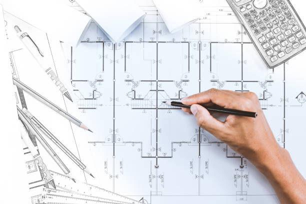 istock Close-up of person engineer hand drawing plan on blue print with architect instrument at office desk. 820965448