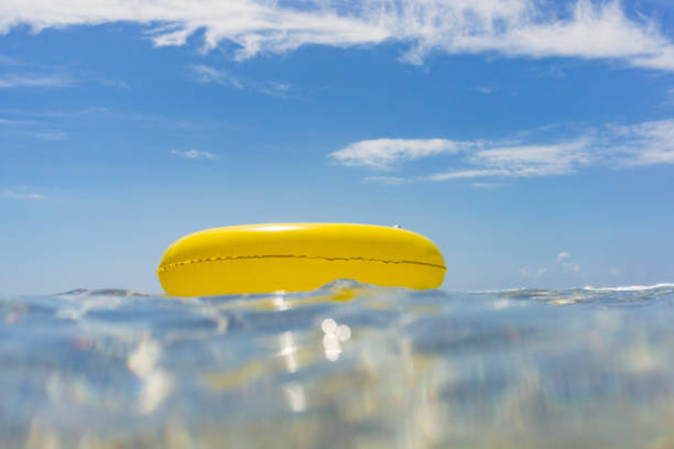 istock Yellow rubber ring floating on the sea, Pedn Vounder Beach 820968594