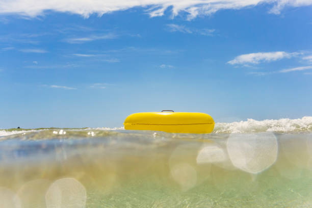 istock Yellow rubber ring floating on the sea, Pedn Vounder Beach 820968616
