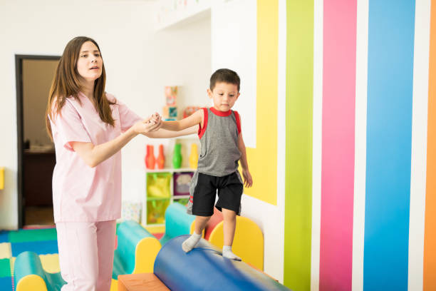 istock Therapist helping a kid with balance 820969160