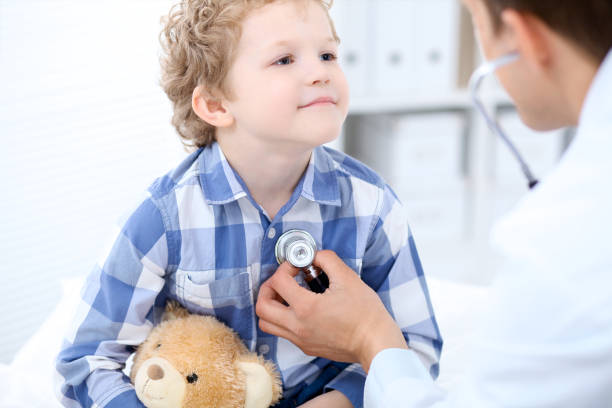 istock Doctor examining a child  patient by stethoscope 820974342