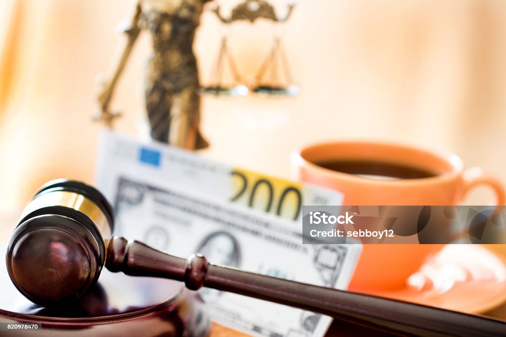 Law concept. Gavel, statue, money and coffee on wooden table Breakfast Stock Photo