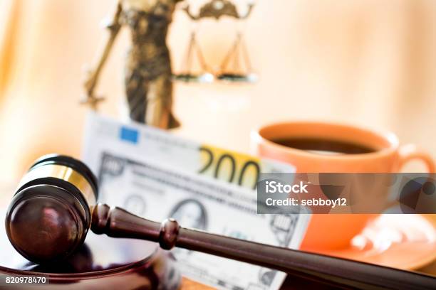 Law Concept Gavel Statue Money And Coffee On Wooden Table Stock Photo - Download Image Now