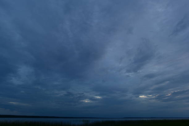 Bad weather cloudy sky dark blue above the lake