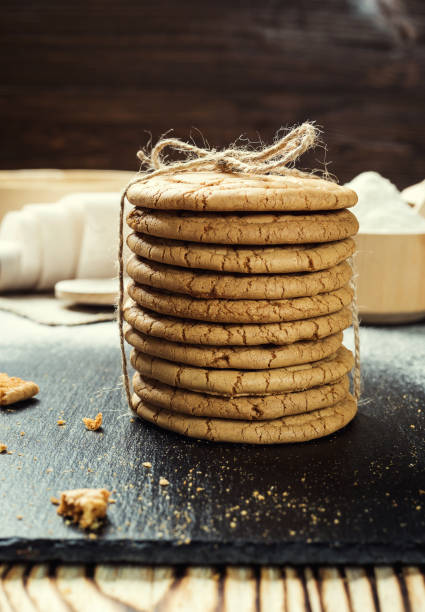 istock Biscuit sweet cookie background. Domestic stacked butter biscuit pattern concept,close up macro.Homemade cookies on wooden table.Cereal biscuits with the sesame,peanuts,sunflower and amaranth. 820985552