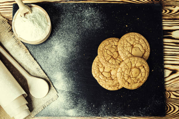 istock Biscuit sweet cookie background. Domestic stacked butter biscuit pattern concept,close up macro.Homemade cookies on wooden table.Cereal biscuits with the sesame,peanuts,sunflower and amaranth. 820985626