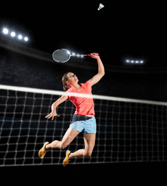 Woman badminton player isolated (sports hall version) Young woman badminton player isolated (sports hall version) badminton stock pictures, royalty-free photos & images
