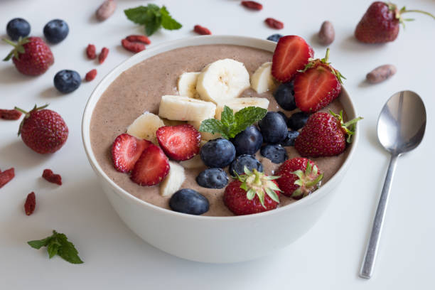 istock Summer breakfast - raw breakfast bowl with strawberries, blueberries and banana 820988912