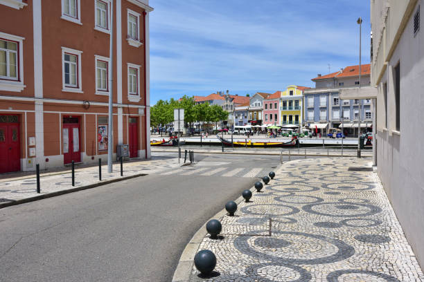 AVEIRO, PORTUGAL - JUNE 10, 2017: Charming street in the tourist town of Aveiro and view on the canal. Aveiro, known as Venice of Portugal, also known for its production of salt, which is used for fertilizer in the area
