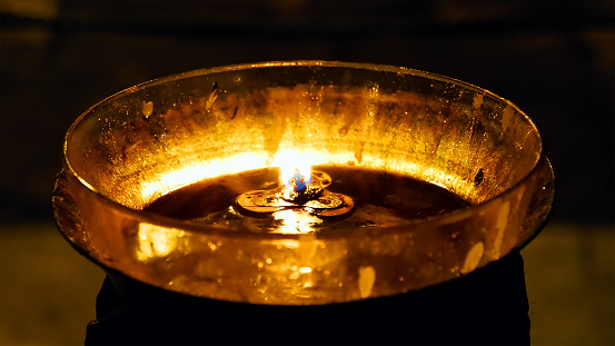 Burning candles in the Holy Sepulcher Church in Jerusalem. The Holy Sepulchre Church and Empty Tomb the most sacred places for all religious Christians in the world.