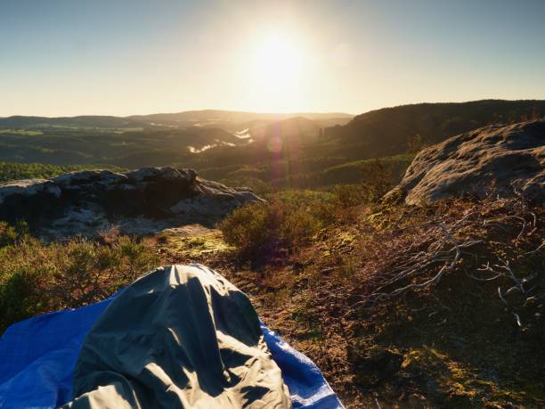 istock Sleeping in nature in sleeping bag. Beautiful awakening in  rocks. View from rocky peak 821008106