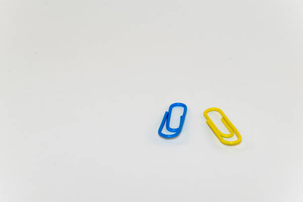 istock Colorful paper clips on white background 821011892