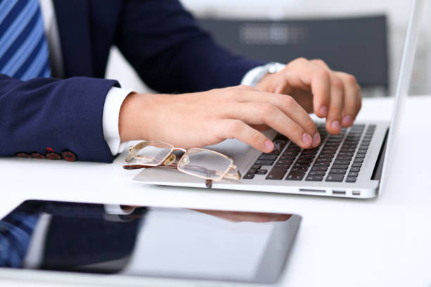 istock Young man working with laptop computer, man's hands on notebook, business person at workplace 821015144
