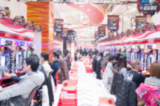 Blurred people playing pachinko slot machine in Tokyo