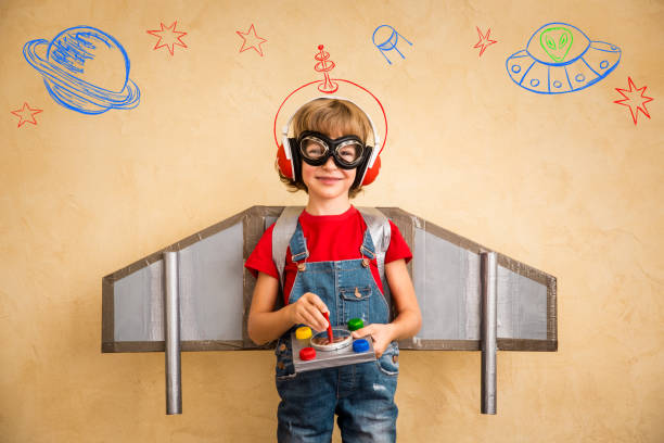 istock Kid pilot with toy jetpack playing at home 821018142