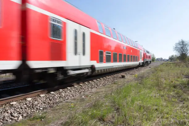 Red railcar pulls railroad wagonRed railcar pulls railroad wagon