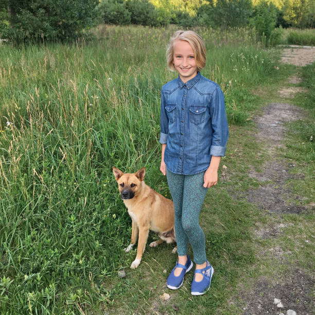 istock Cheerful girl walks with a dog mongrel 821027494