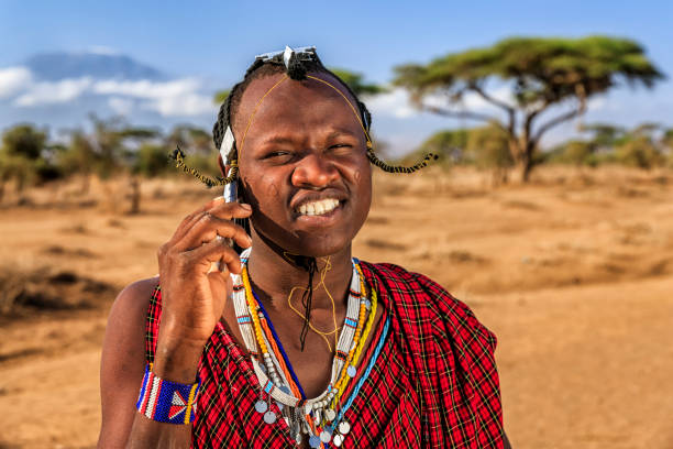 istock Warrior from Maasai tribe using mobile phone, Kenya, Africa 821028680