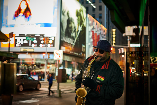 Street musician palying jazz music on saxophone on Manhattan, NeyYork City