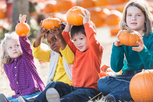 istock Multi-ethnic group of children at pumpkin stand 821040658