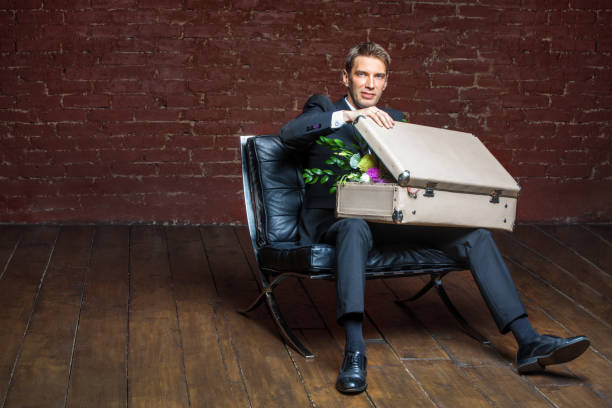 istock groom pulls out a suitcase with a bouquet of flowers 821045736