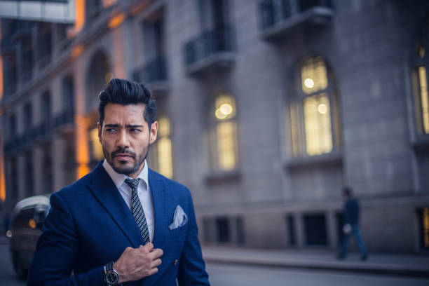 Young businessman standing on the city street