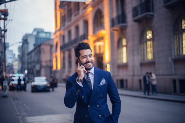 istock Handsome businessman talking on mobile phone outdoors 821046132
