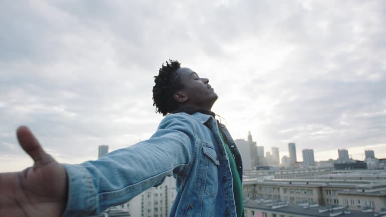 African man closed eyes. Cityscape in the background