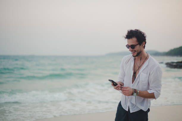 istock Listening music at the beach 821054948