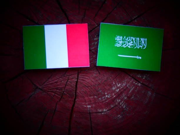 istock Italian flag with Saudi Arabian flag on a tree stump isolated 821057370