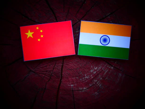 istock Chinese flag with Indian flag on a tree stump isolated 821065288