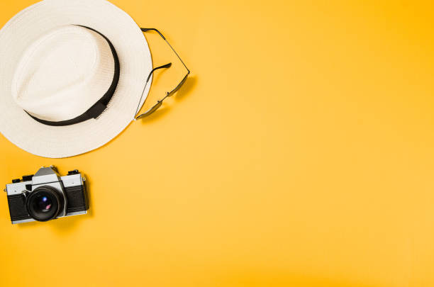 Accessories for travel top view yellow background with copy space
