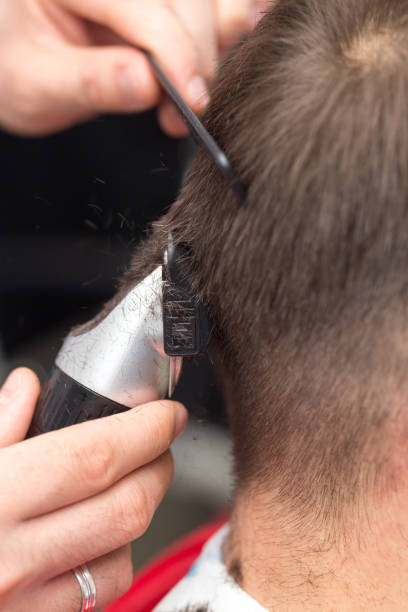 istock Man having a haircut with a hair clippers 821080112