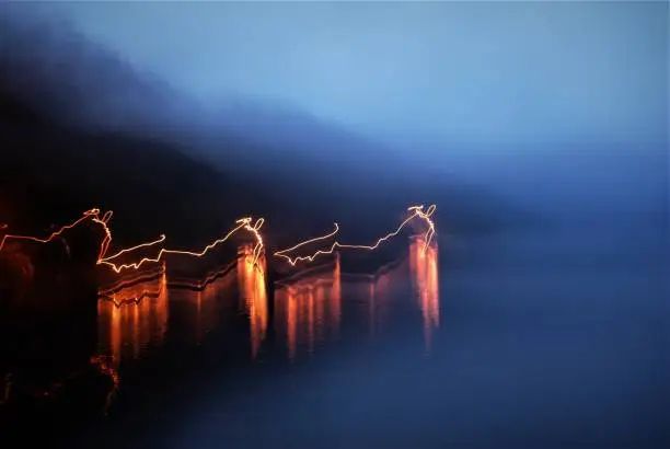 A road across a river in Nikko Japan lit by cars -- I was too cold to keep the camera steady.