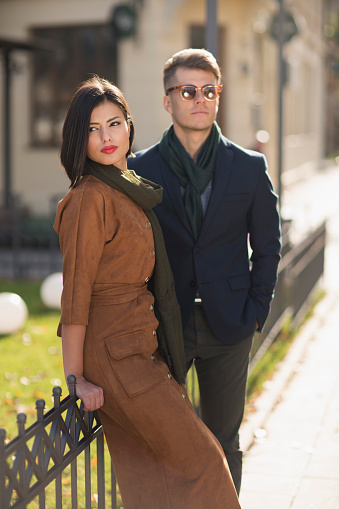Portrait of a stylish young couple posing outdoors.