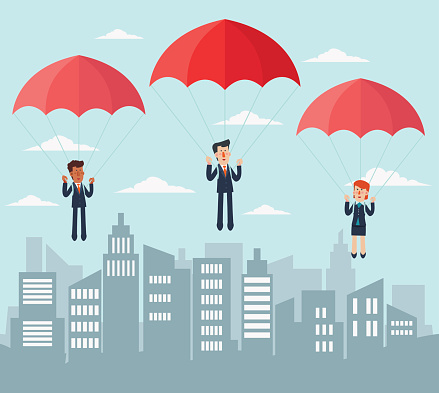 Business people with parachute over city