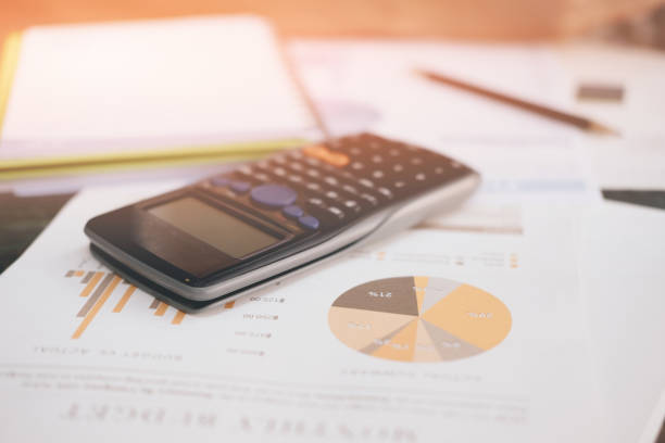 istock Close up a calculator financial data, tax, supplies, analysis chart and notepad on work desk 821114016