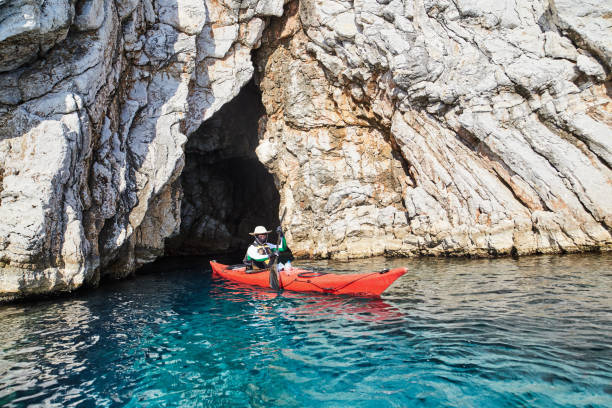 istock A man coming out of a cave with kayaking 821130498