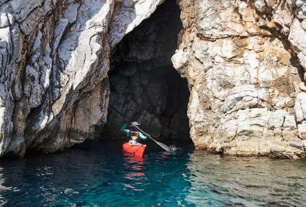 istock A man coming out of a cave with kayaking 821130756
