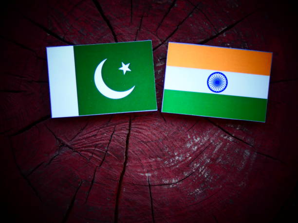 Pakistan flag with Indian flag on a tree stump isolated stock photo