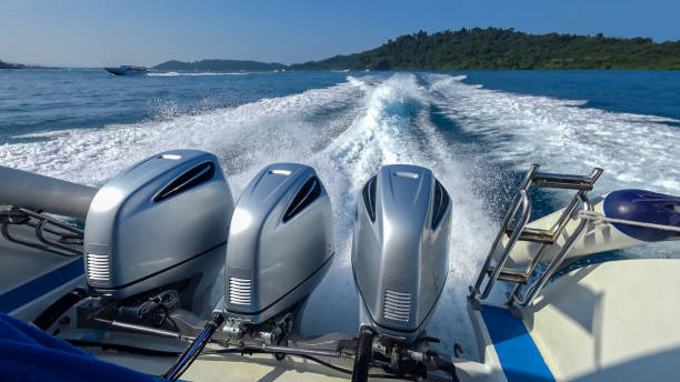 Rear view from a Speedboat. Wake wave behind the boat with three engines - in the background is an exotic landscape