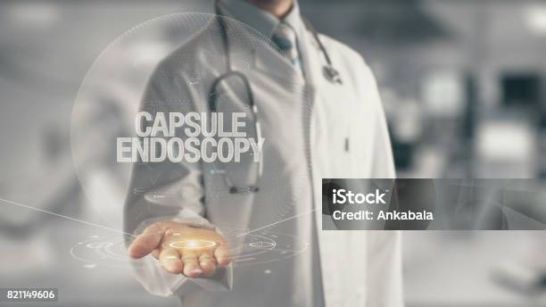 Doctor Holding In Hand Capsule Endoscopy Stock Photo - Download Image Now - Capsule - Medicine, Endoscope, Doctor