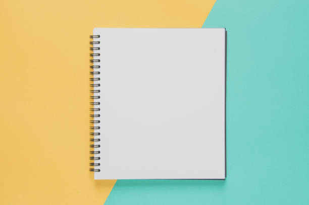istock Office workplace minimal concept. Blank notebook on yellow and blue background. 821150580
