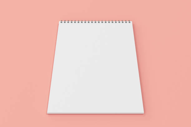 istock Blank white notebook with metal spiral bound on red background 821154444