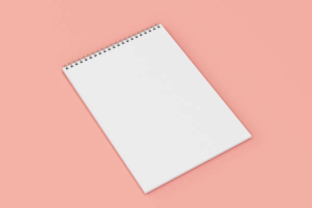 istock Blank white notebook with metal spiral bound on red background 821154468