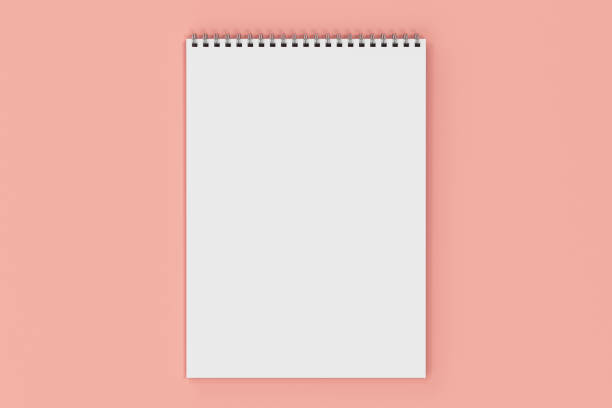 istock Blank white notebook with metal spiral bound on red background 821154530