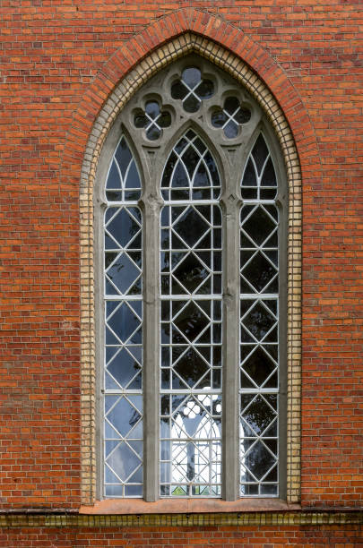 istock The old window in the red brick wall. 821161410